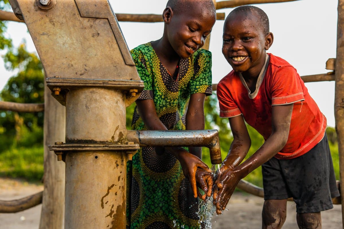 Children using a clean water pump